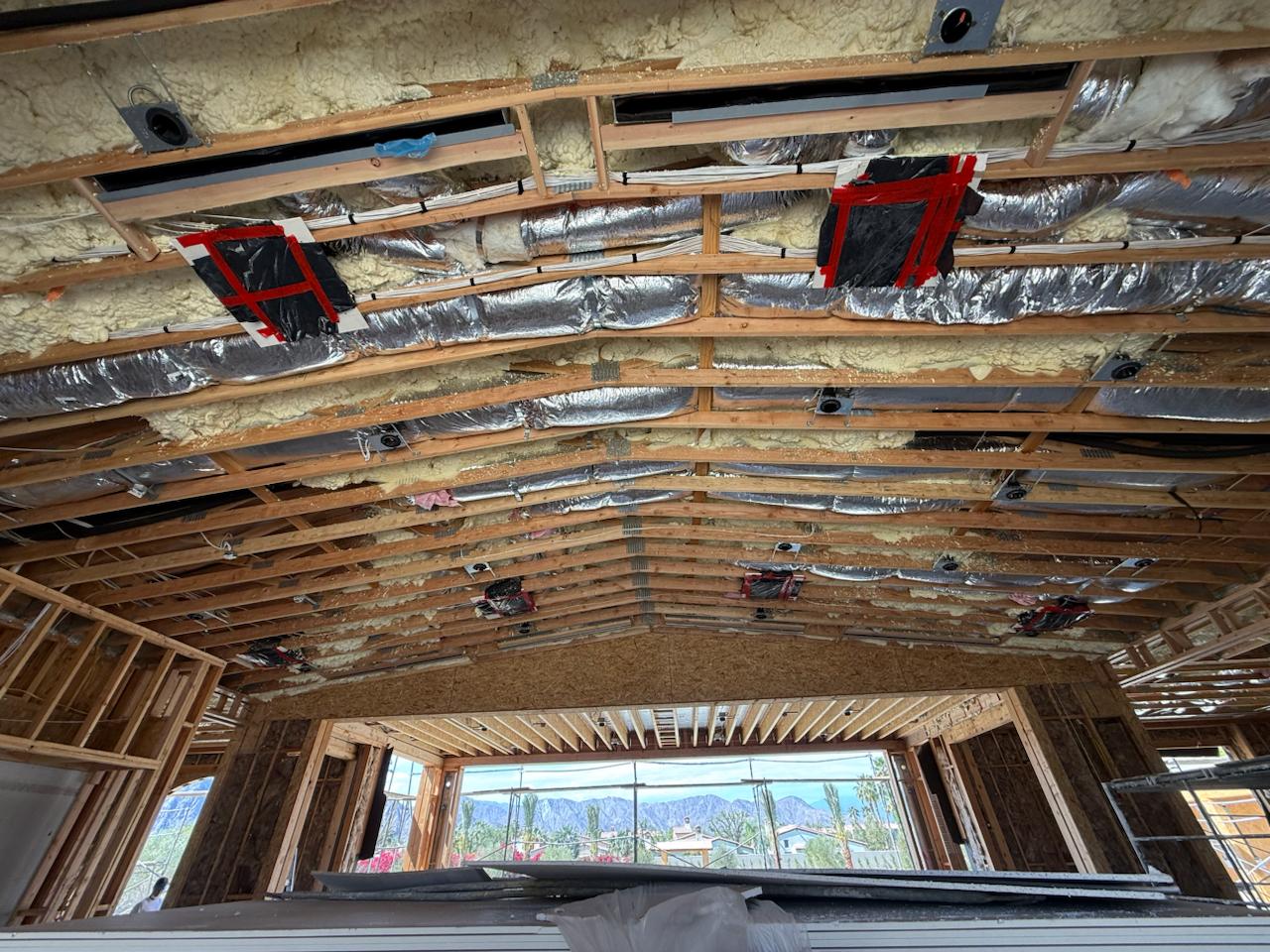 Overhead view of ceiling duct rough-in with Santa Rosa Mountains visible through windows