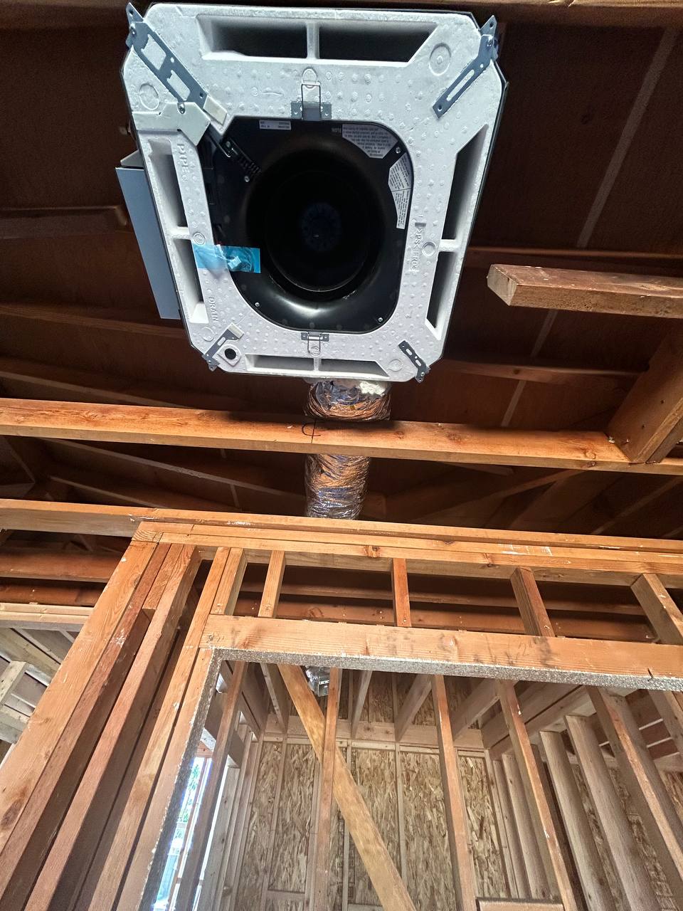 Fujitsu concealed ceiling cassette close-up showing blower wheel and body in framing