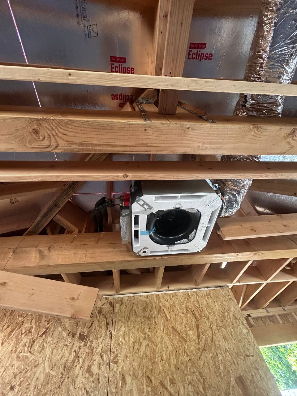 Wide angle view of Fujitsu cassette between ceiling joists with Eclipse radiant barrier insulation