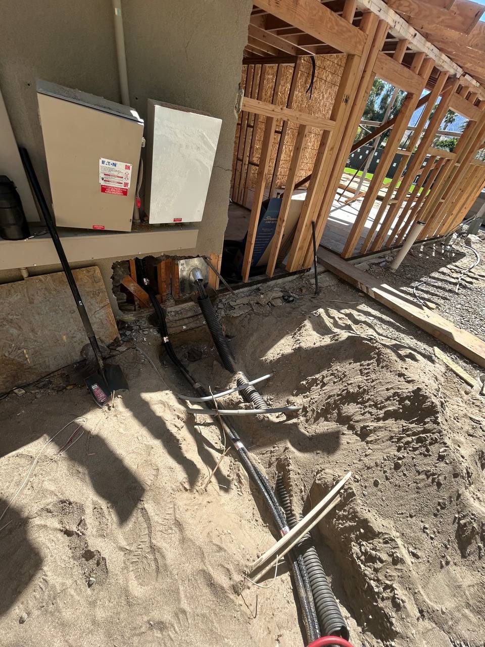 Trenched refrigerant lines in corrugated protective drainage tubing for underground run to condenser