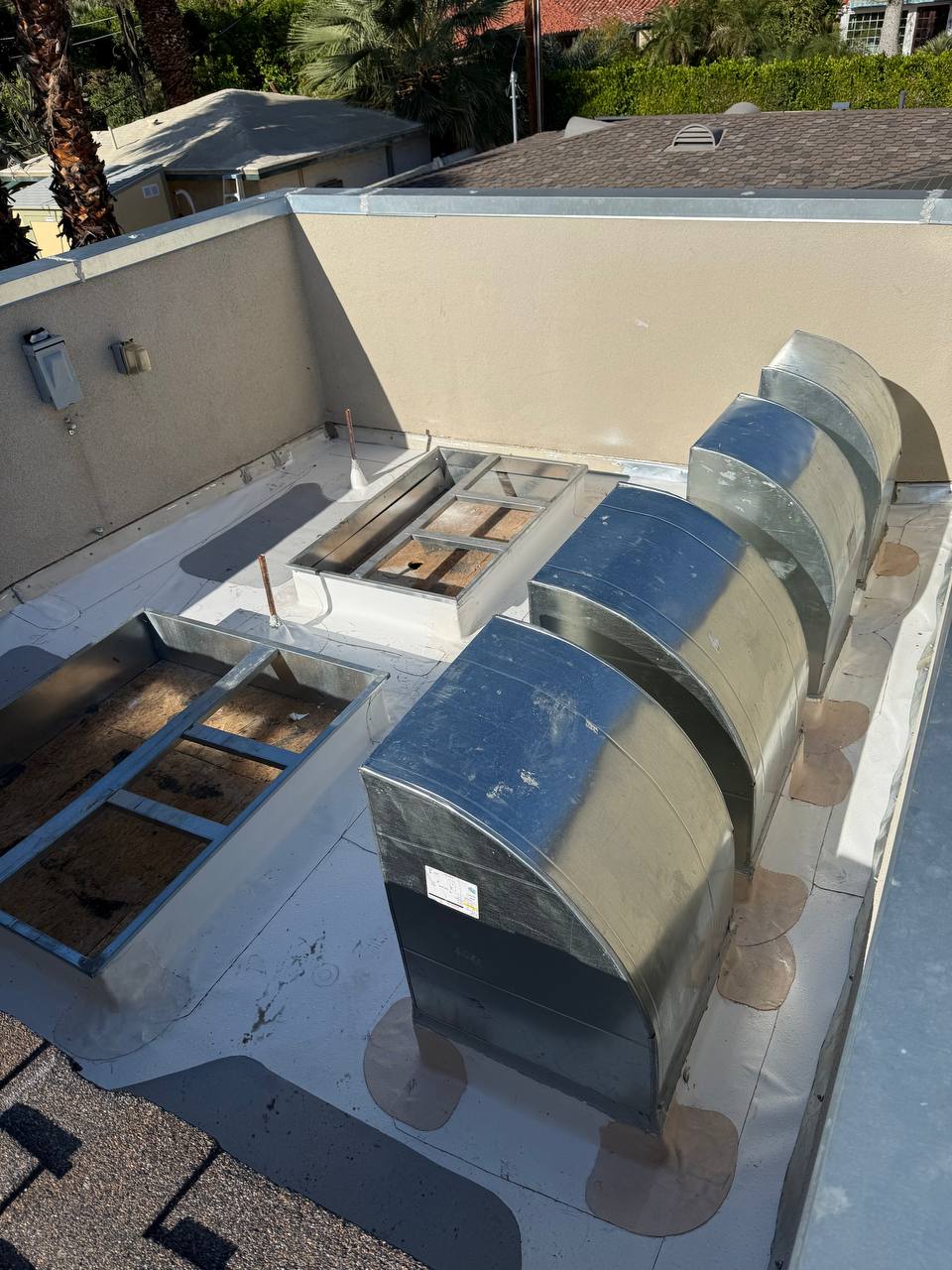 Custom plenums installed on roof — overhead view showing both plenum housings