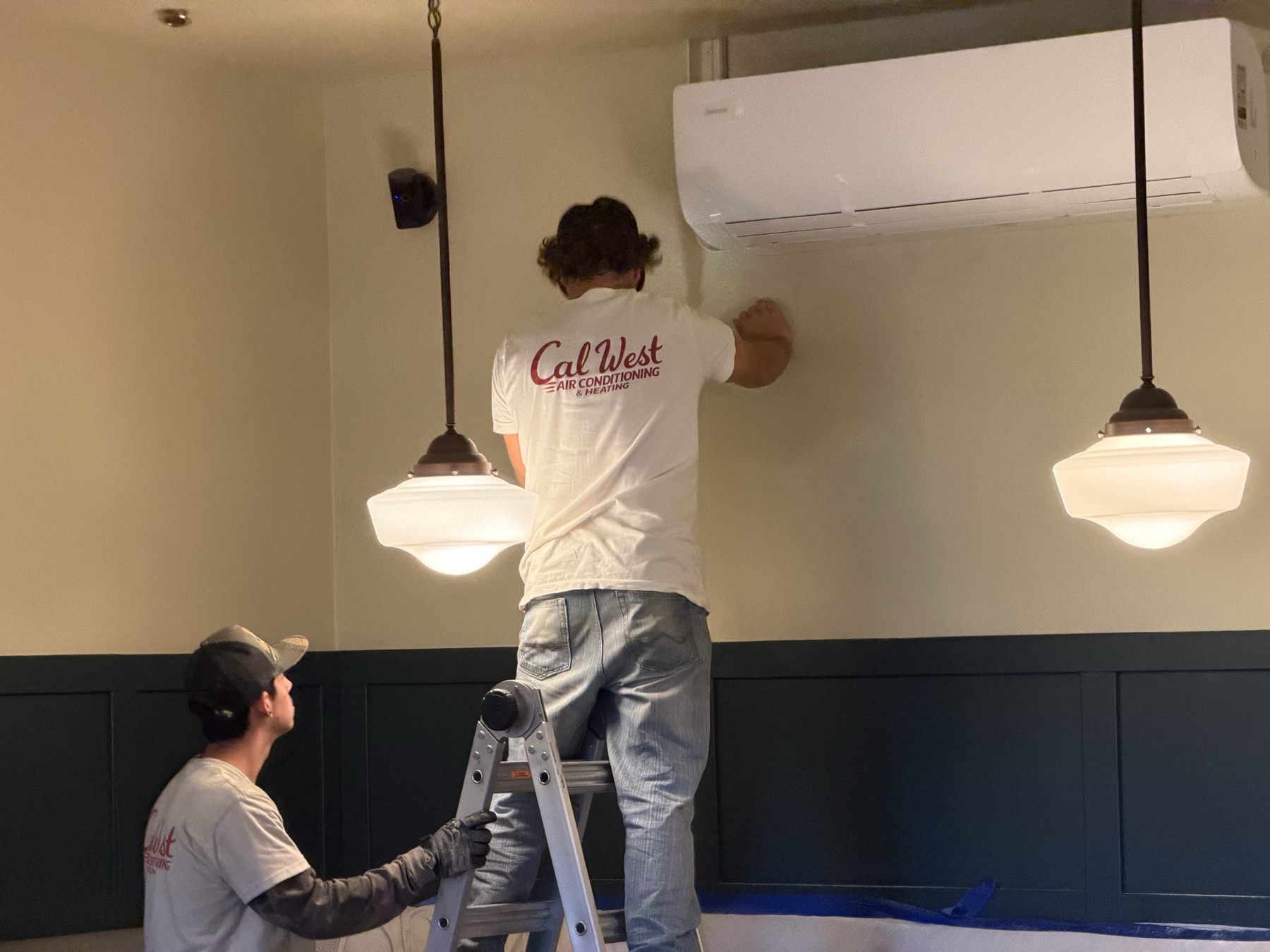 Cal West crew mounting the 36,000 BTU indoor mini-split unit in the dining room